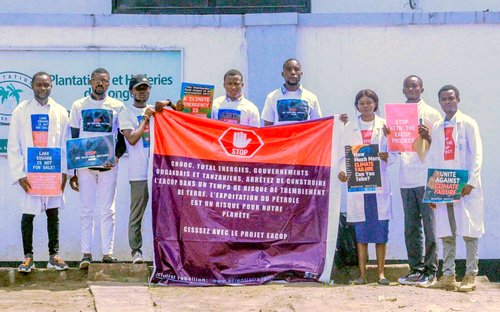 scientists stand together holding banners and signs